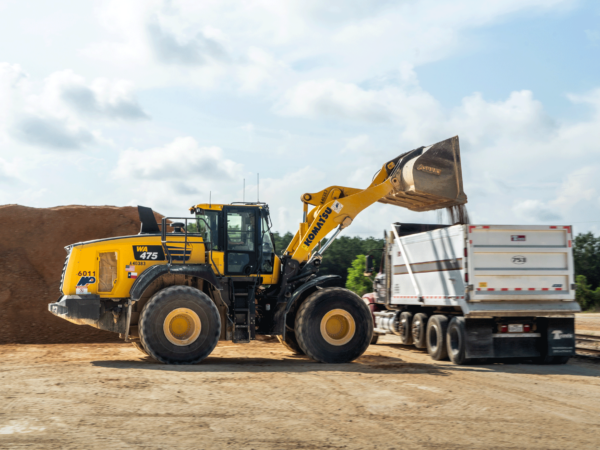 Front loader dumping into trailer.