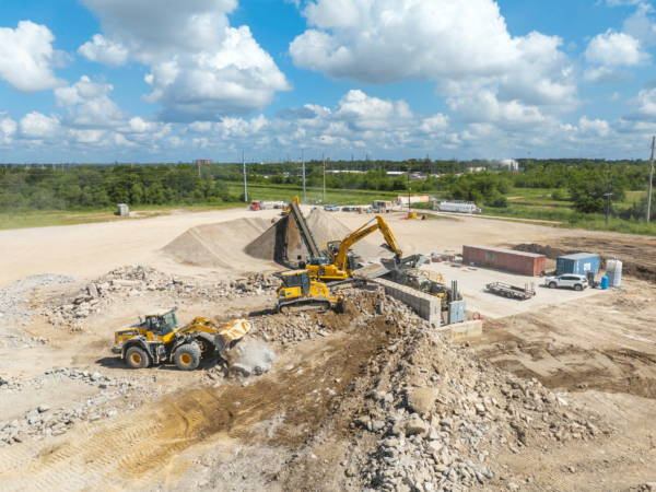 Aerial shot of a jobsite, with a front loader and excavator visible.